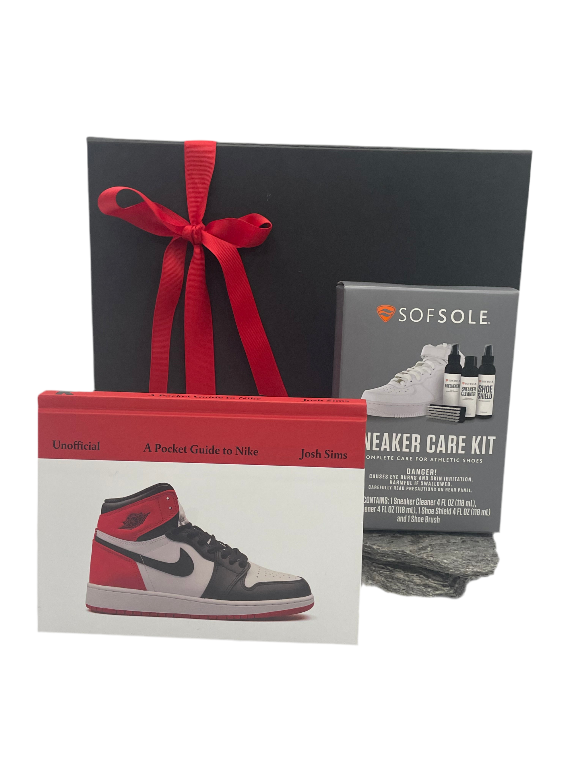 Collection of sneaker care items including a book, care kit, and care guide on a white background.