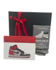 Collection of sneaker care items including a book, care kit, and care guide on a white background.